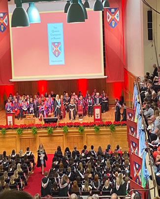 a closer photo showing the students now walking across the stage to recieve their certificates.