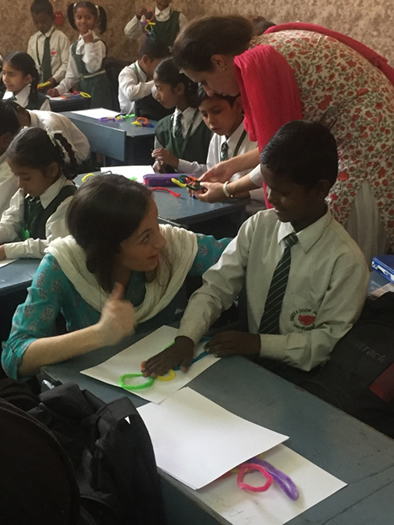 St Mary's students Ríoghnach Moore and Aisling Chada in class with the children of Sneha Doon Academy.