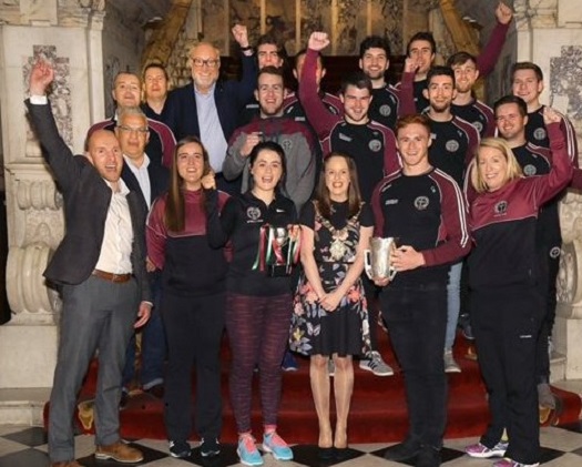 Staff and students celebrate at City Hall reception for St Mary's Gaelic football and netball Teams